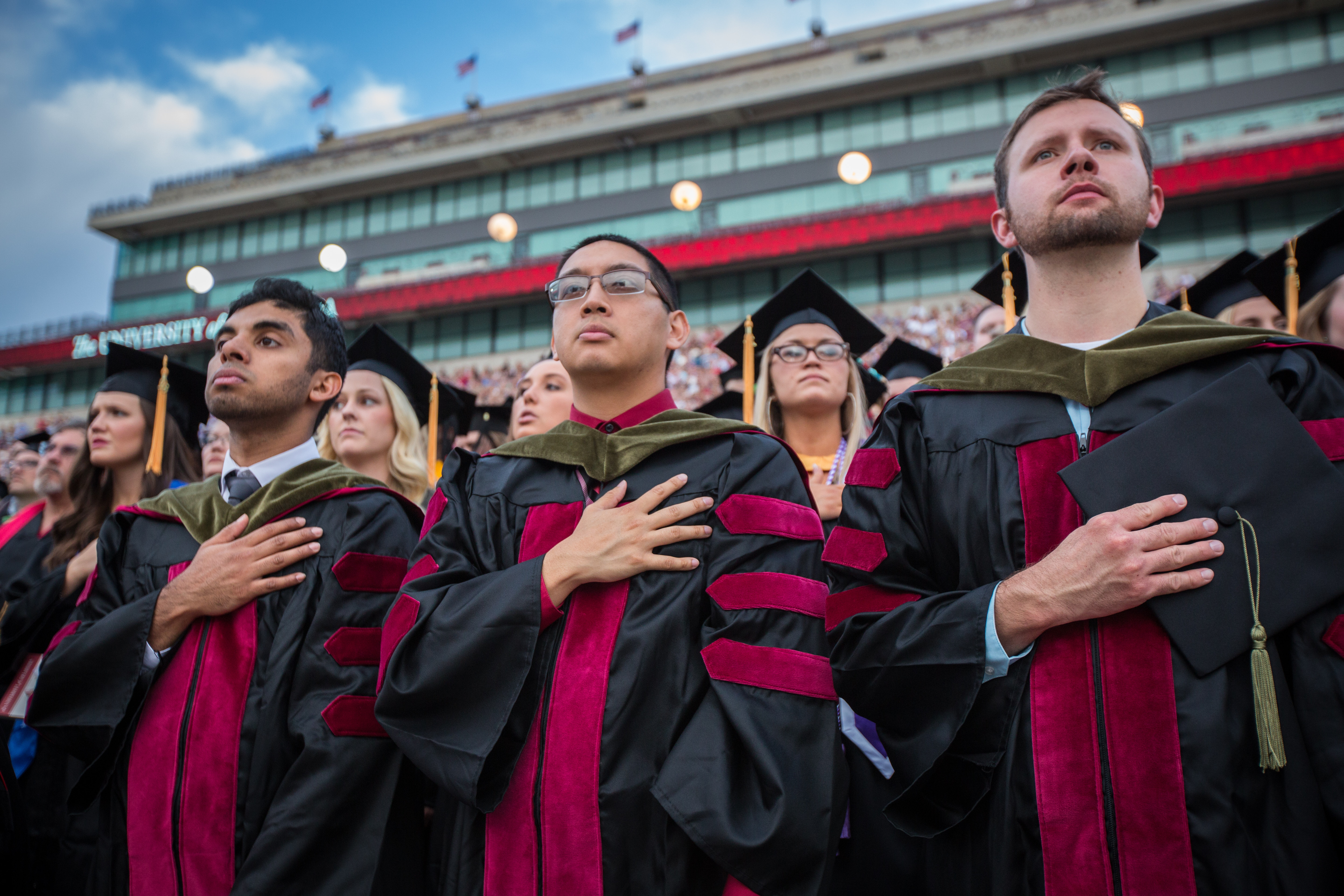 Students in graduate attire attend a celebration at the University of Oklahoma.