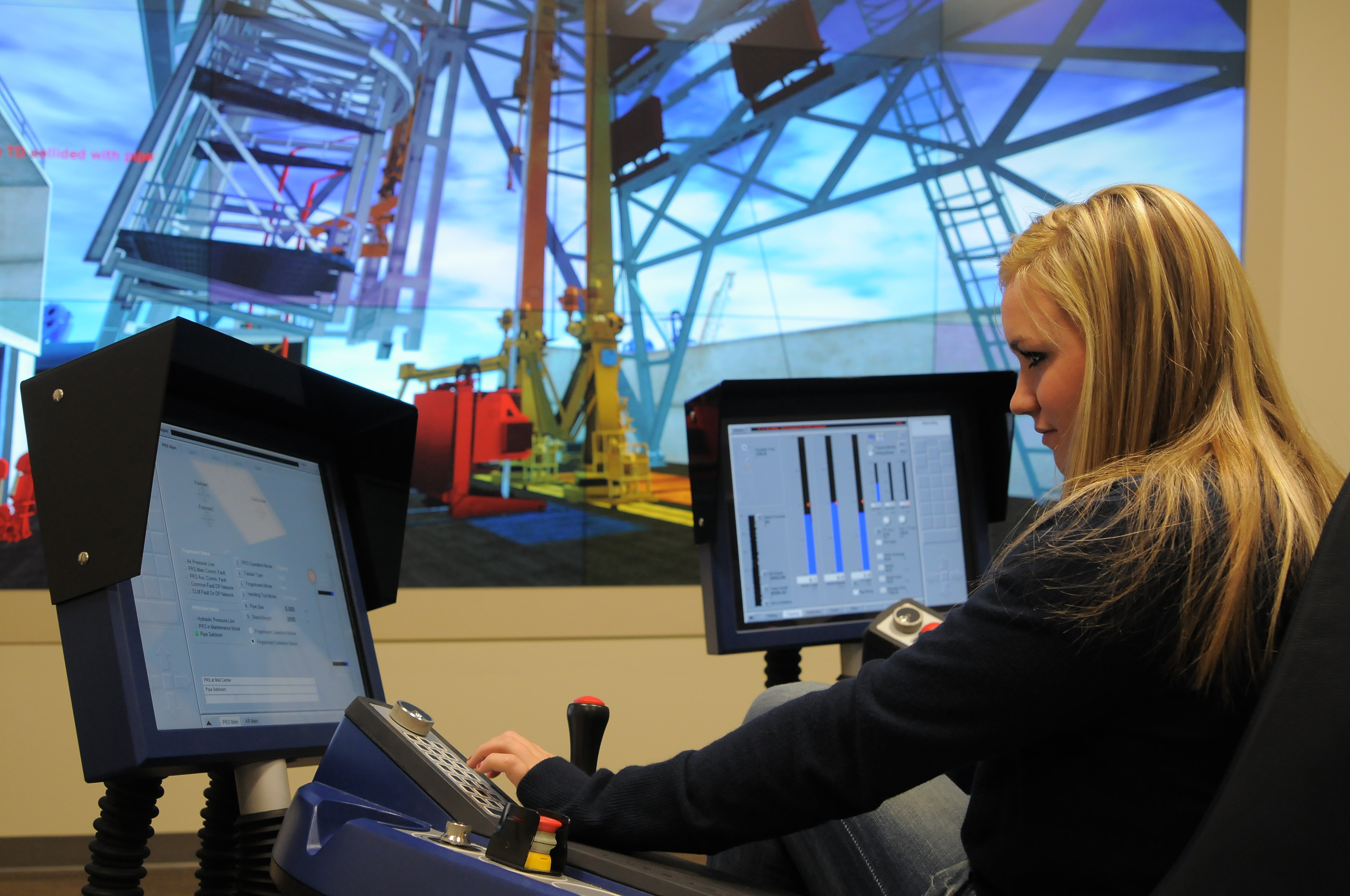 A woman sitting at a simulator.