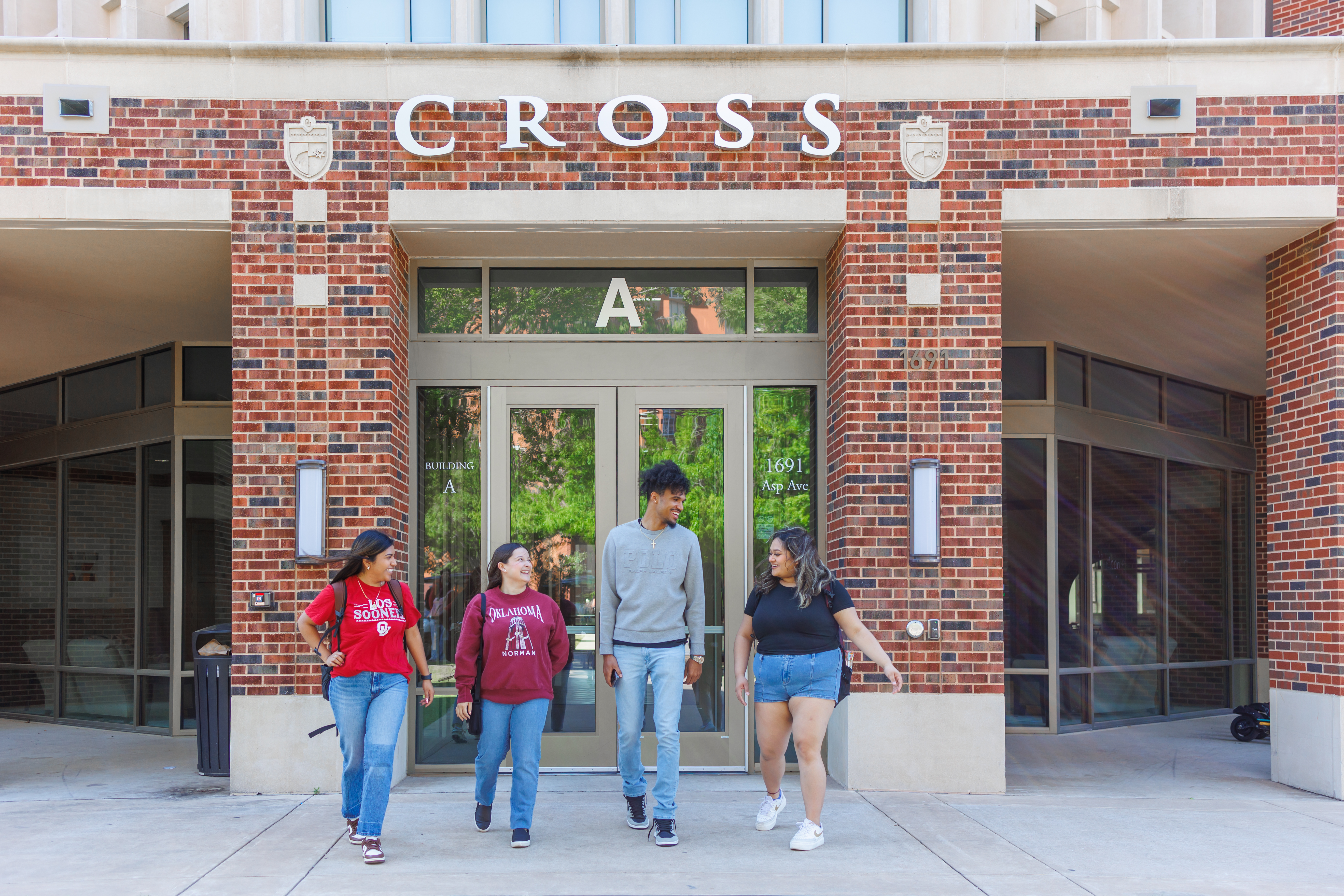 Four students walking outside Cross