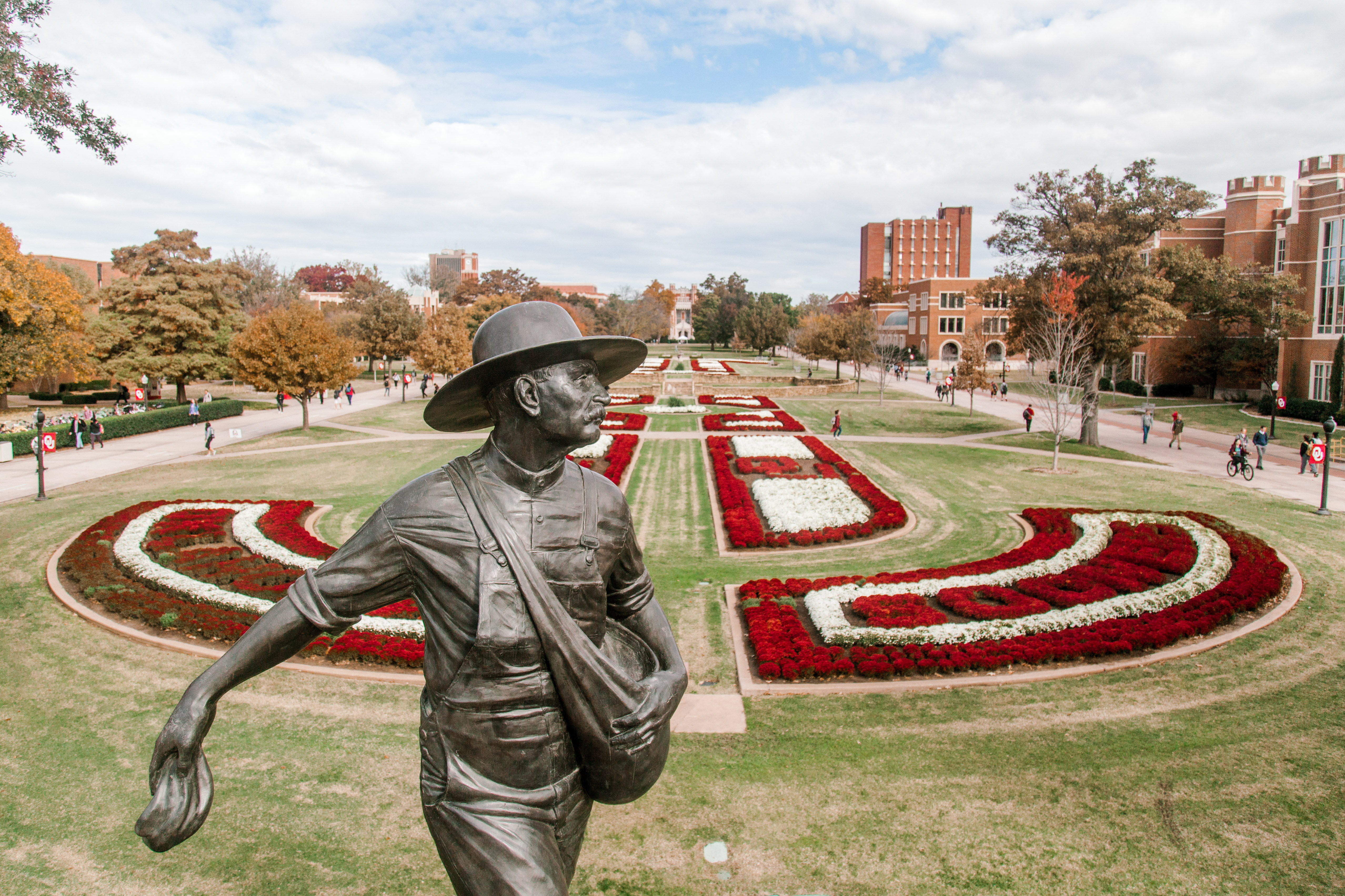 Seed sower statue with south oval mums behind it