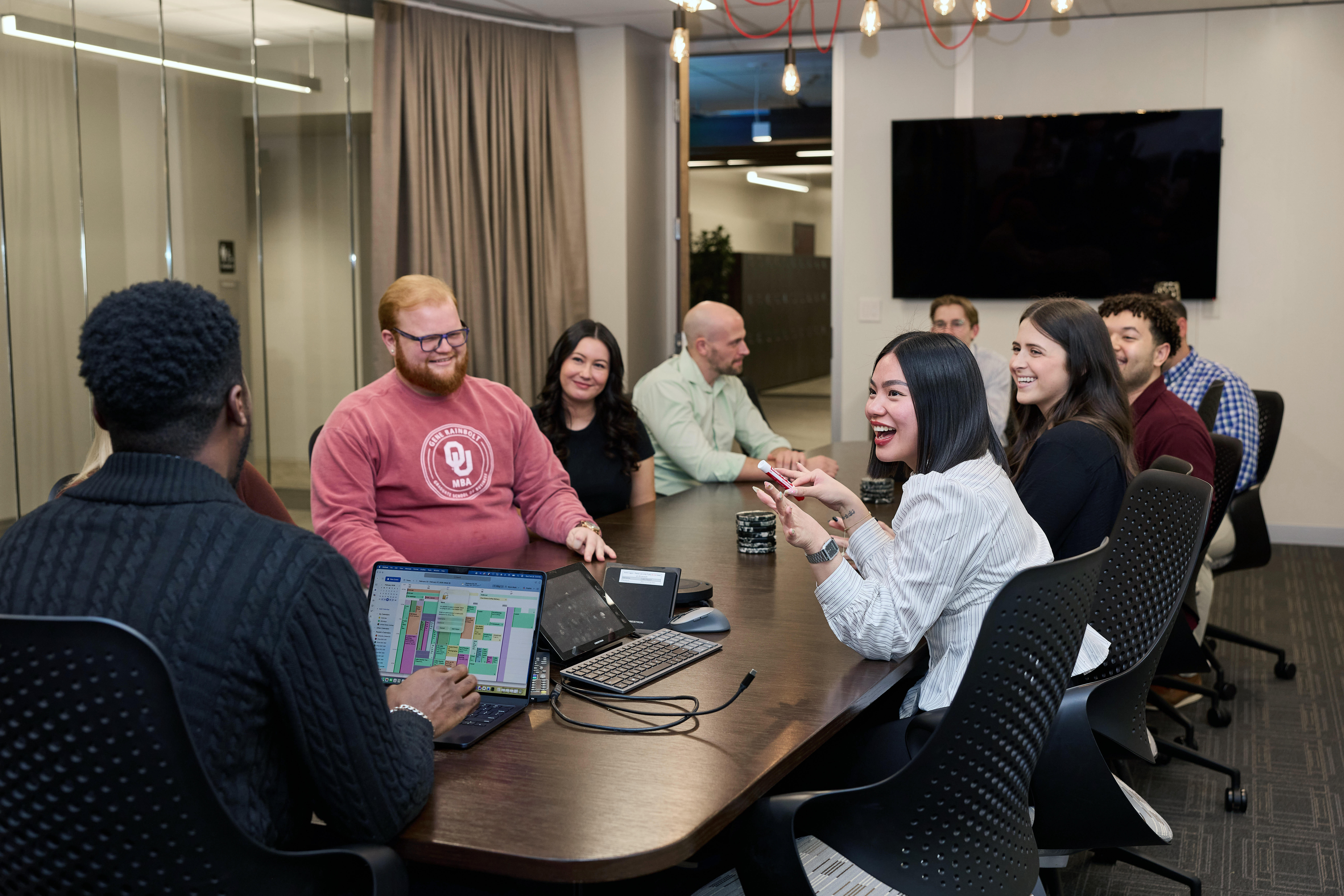 Group of OU students collaborating around a table.