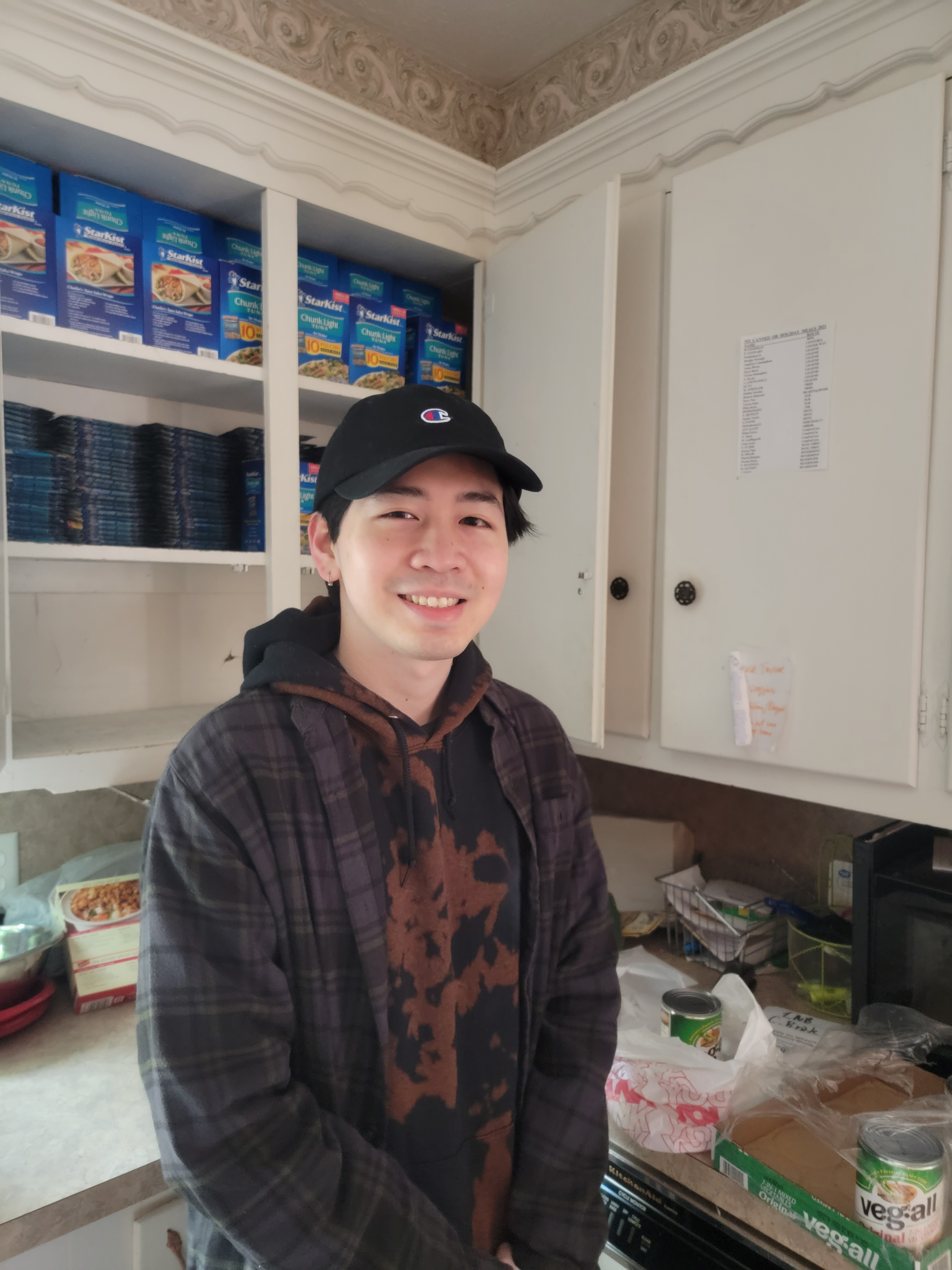 OU federal work study student, Tony Dang, putting together Meals on Wheels.