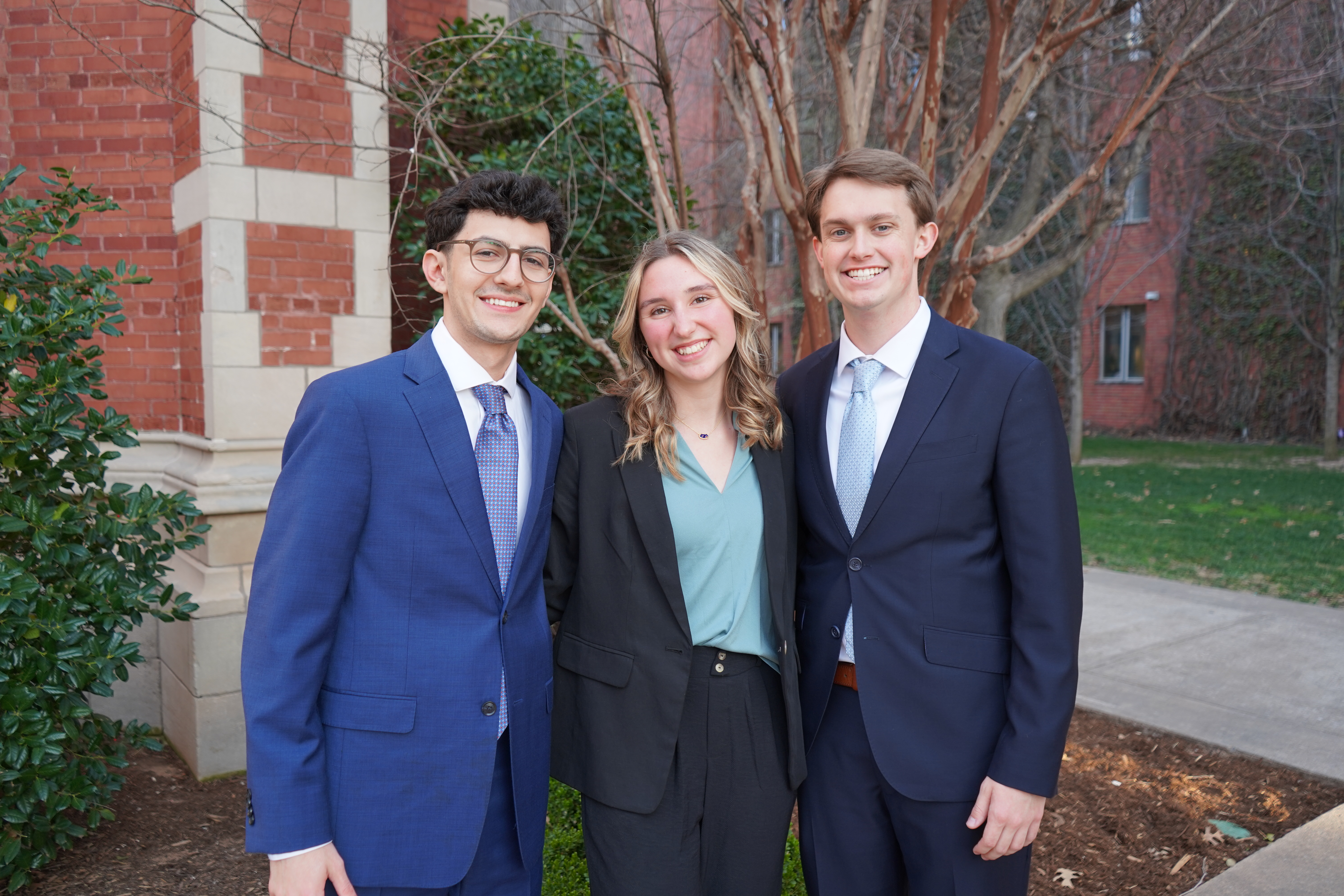 Three students in professional clothing.