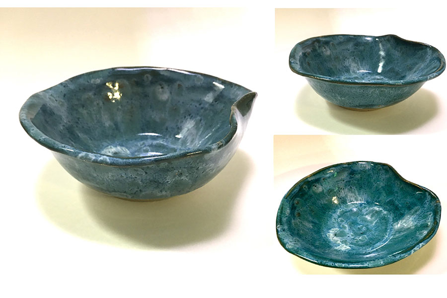 A blue and green glazed ceramic bowl formed like a leaf.