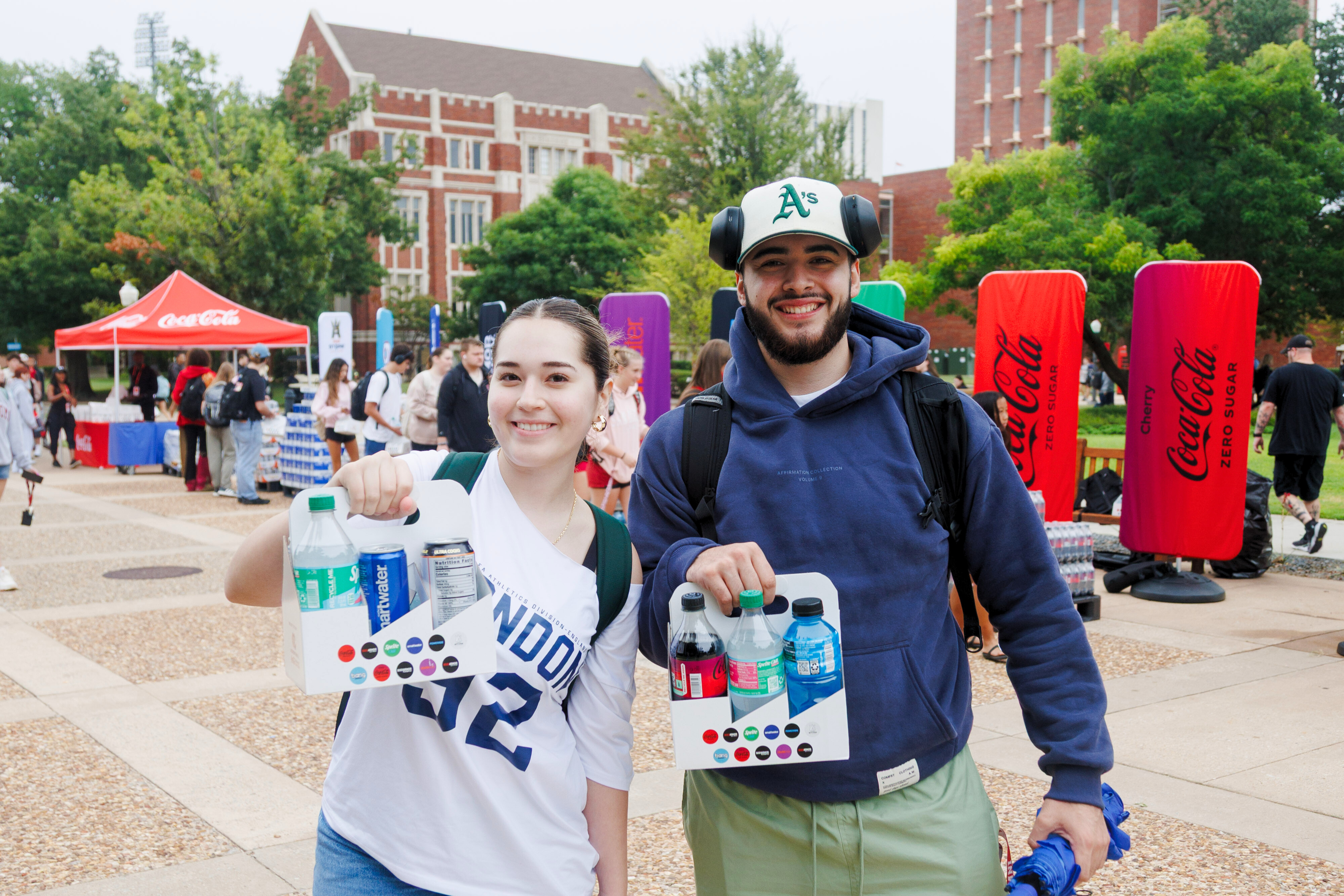 Students holding up giveaway items at a Strategic Initiatives event.