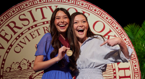 Two OU students receiving awards at the campus awards program. 