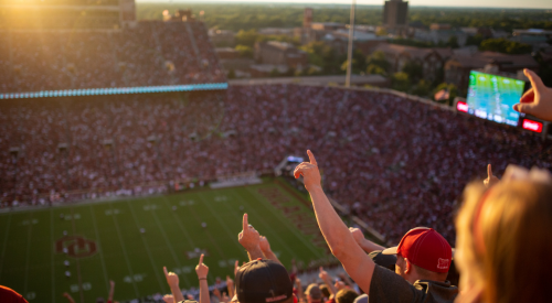 Fans cheering at an OU football game. 