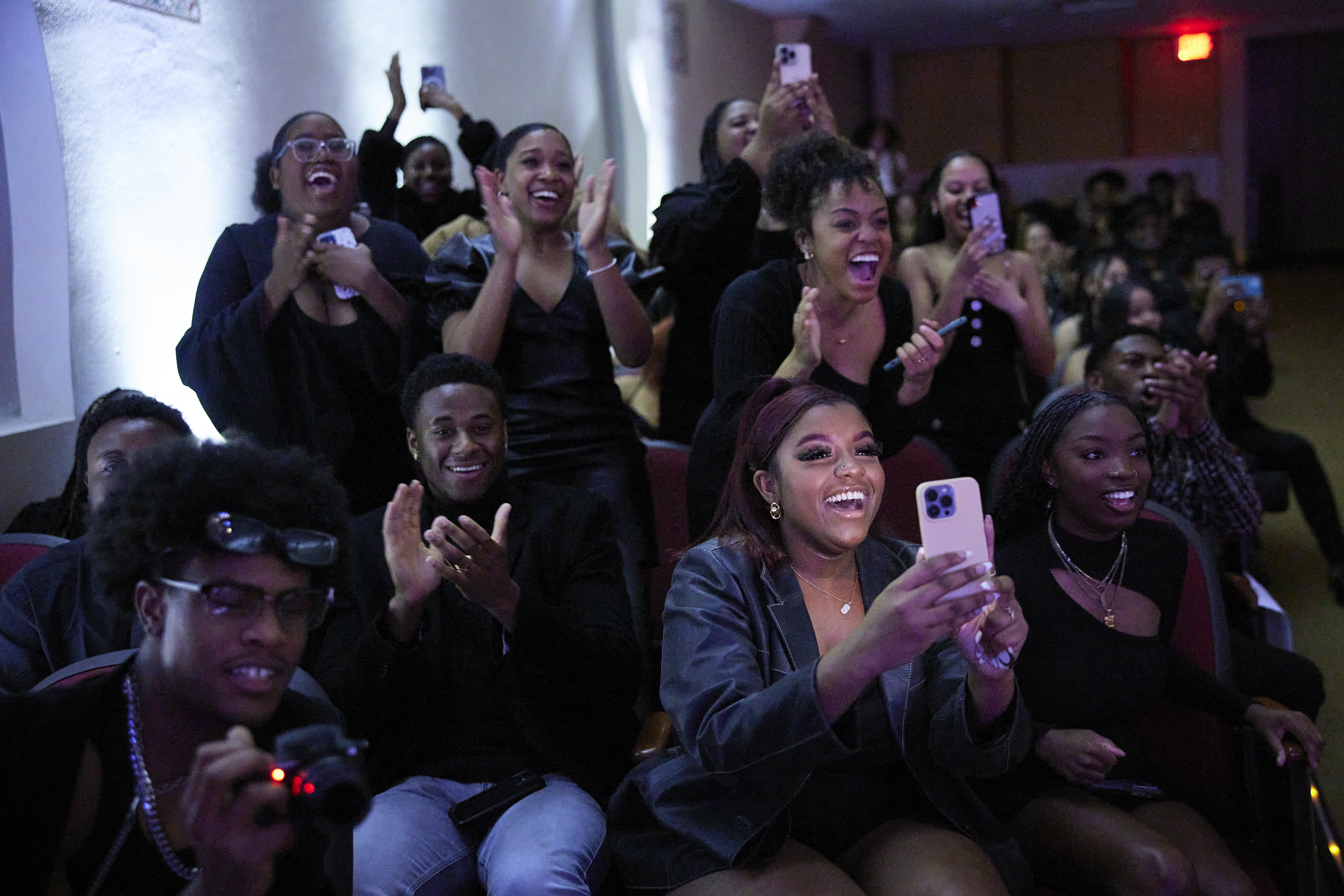 Students cheering and taking photos of a friend during the OU Black Royalty Pageant.