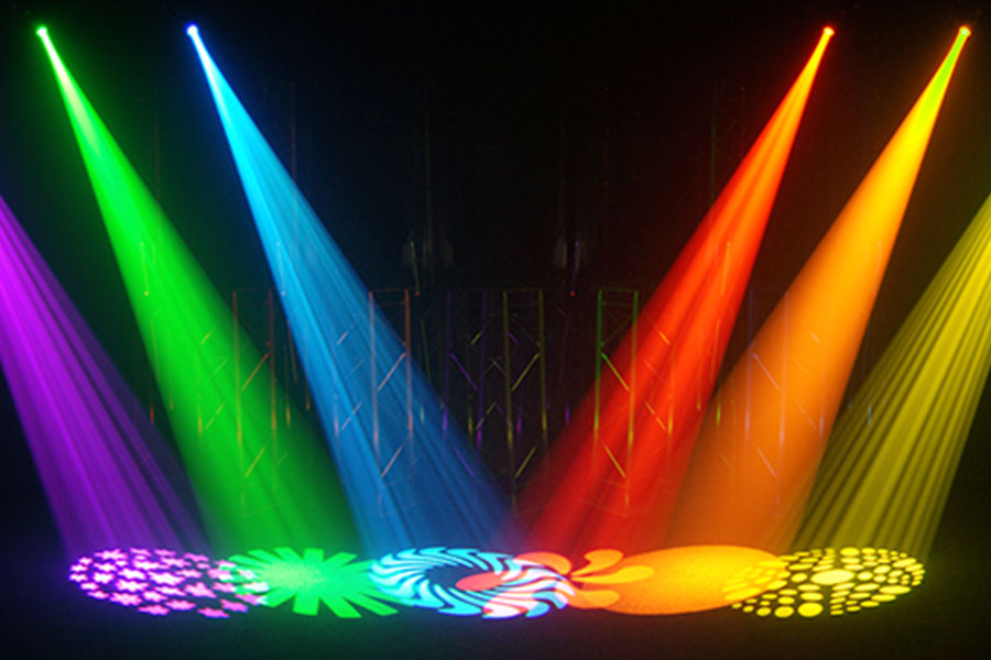 A multi-colored lighting shining onto floor with different designs projected from each light.