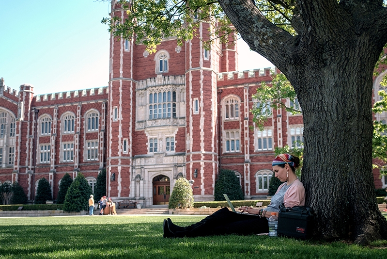 Student sitting under a tree