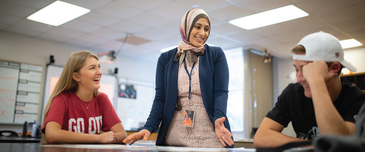 Eman Beck with two students