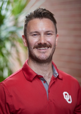 headshot of Cian Brown in a red OU polo