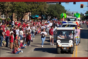 Picture of the JRCoE cart driving down the street in the parade