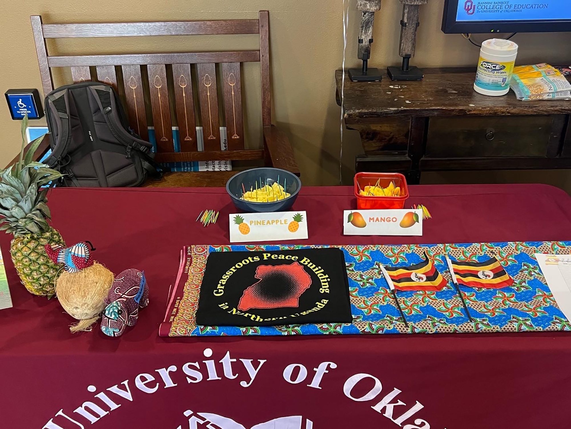 a table with Ugandan flags and fruits