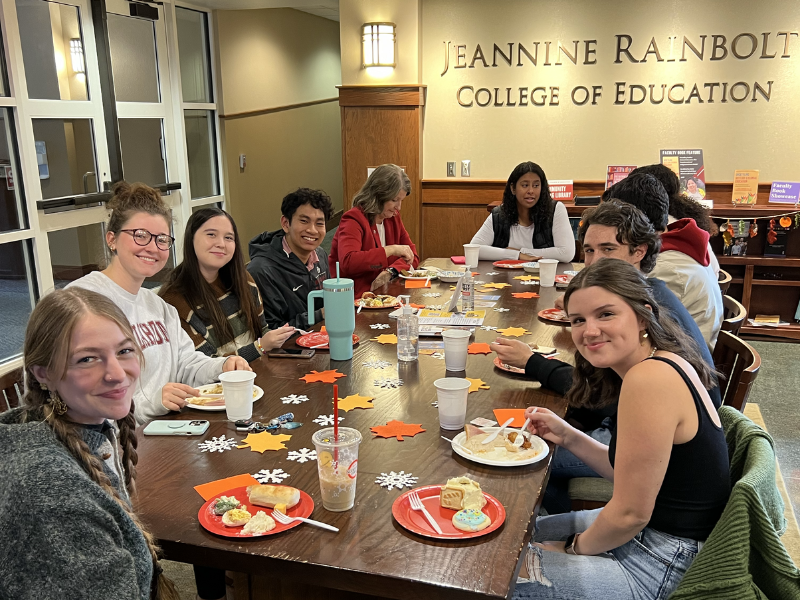 students sitting around a large table eating a meal