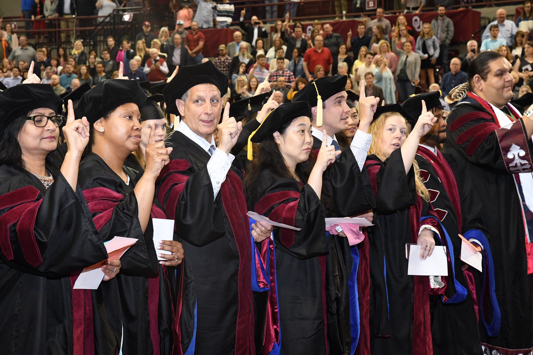 JRCoE students singing OU chant at graduation