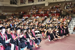 Students sitting in chairs at graduation