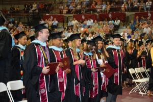 row of M.Ed. students standing
