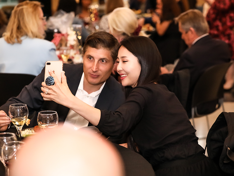 Man and woman sitting together posing for a selfie