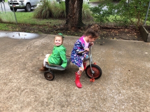 Two children playing on a scooter