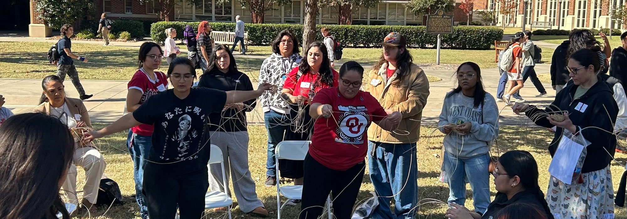 OU employees leading students in a group outdoor activity.