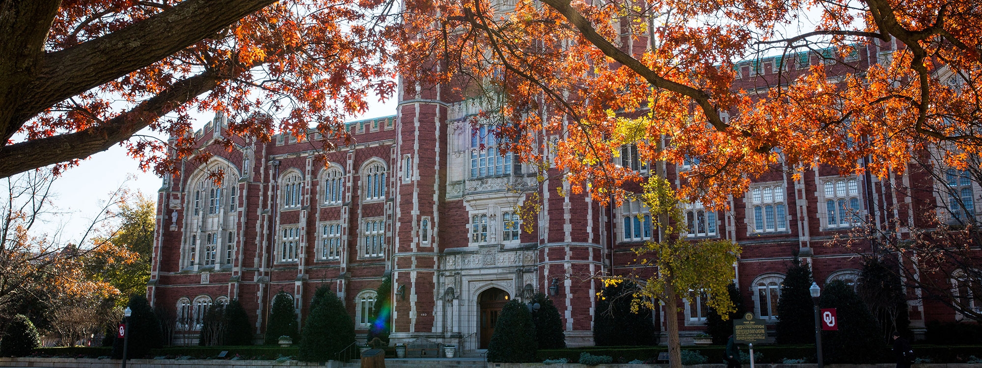 Evans Hall on the O U Norman campus, surrounded by trees in the fall.
