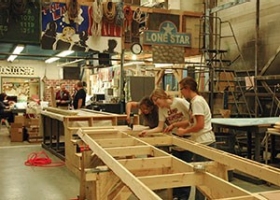 students lay out wood panels for set design