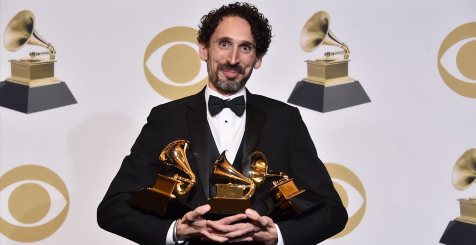 John Daversa holding grammy awards