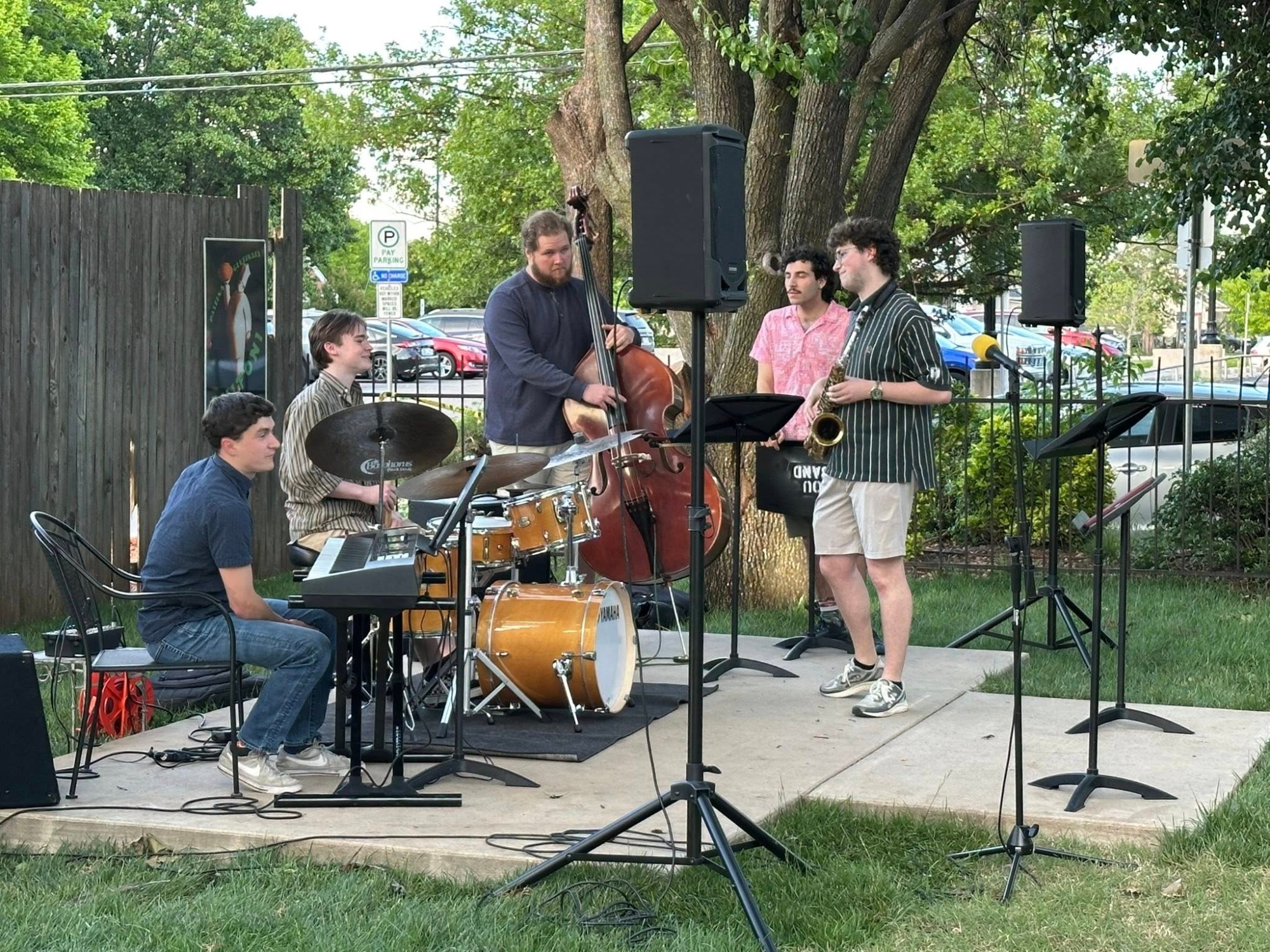 Jazz combo performing outdoors at restaurant.