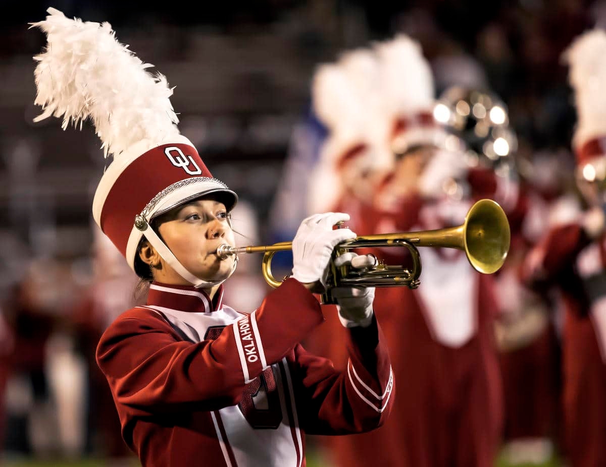 Trumpet player performing in uniform.