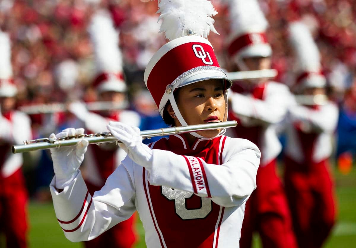 Pride of Oklahoma flautist performing on the field.