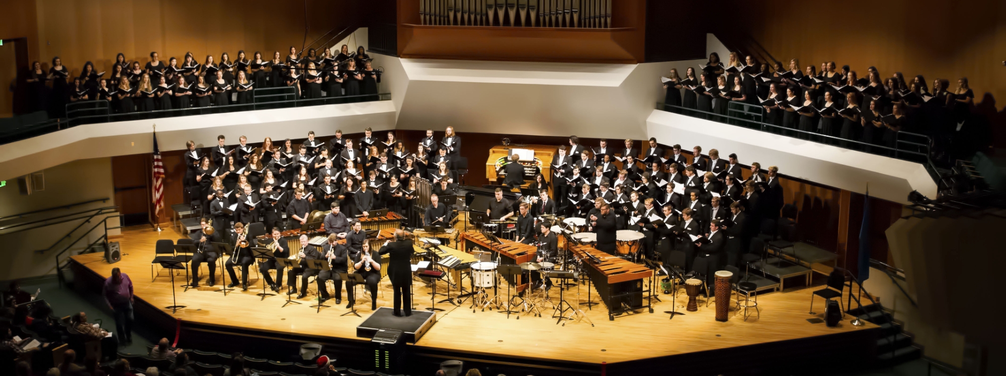 OU Combined choirs and brass players on stage in Sharp Hall for Christmas at OU.