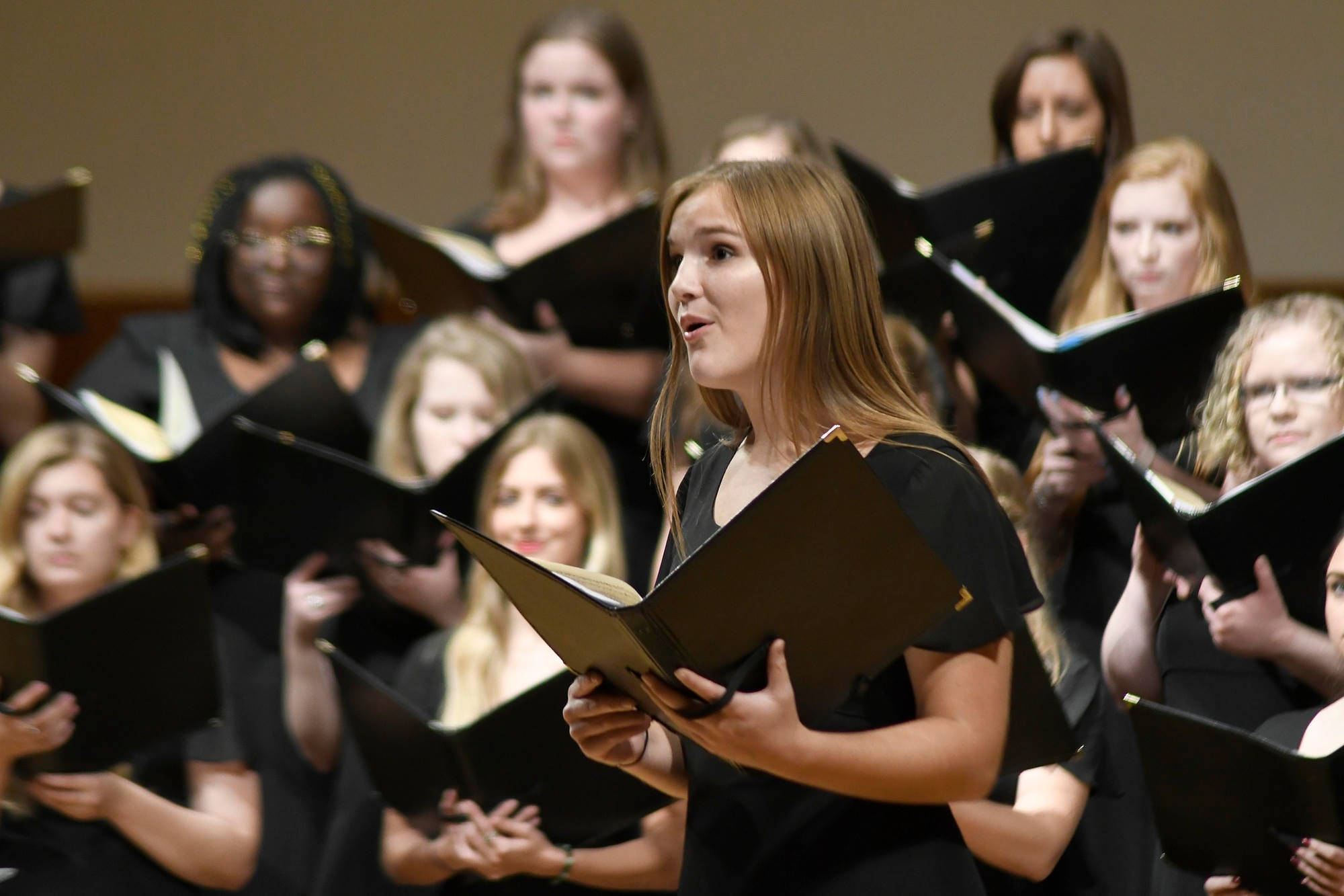 Vocal soloist in front of Vox Lyrica in Sharp Hall.