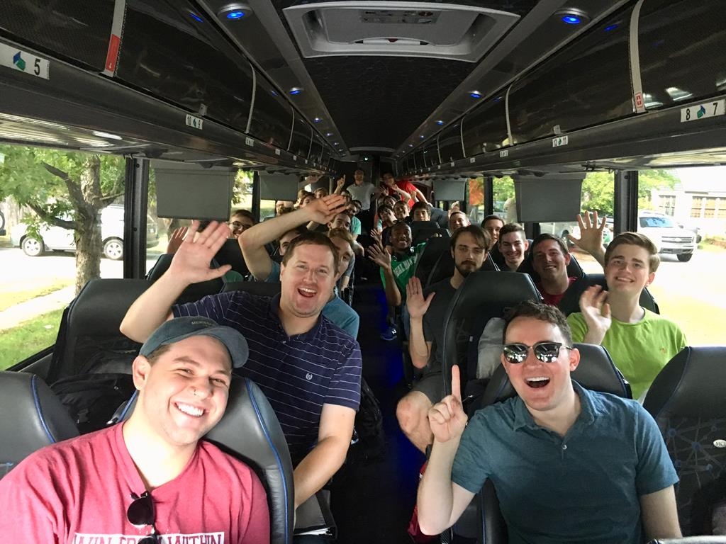 Glee Cub members on charter bus during performance tour.