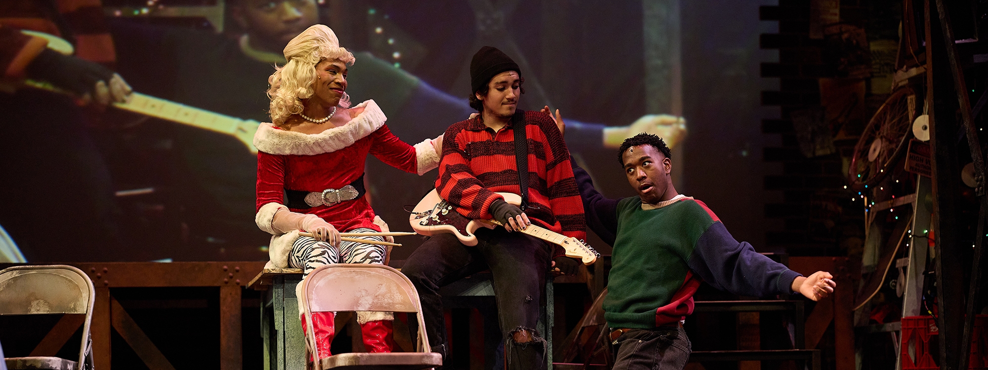 Three musical theatre students in a production of "RENT".