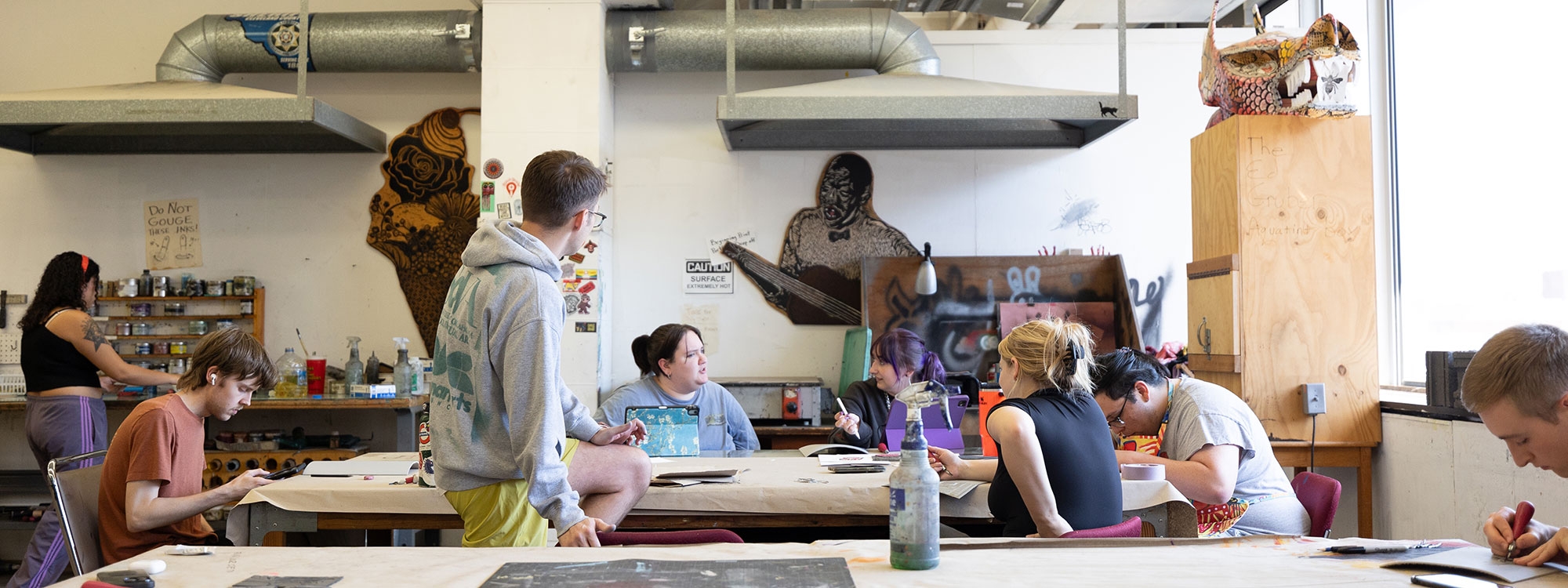 Students discussing projects in art studio. 