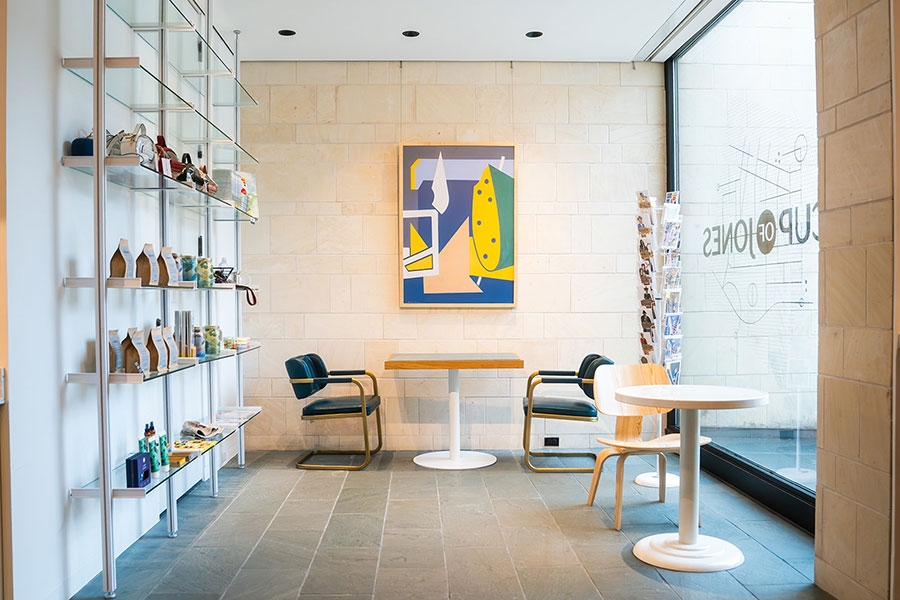 A shop with some tables and chairs inside Cup of Jones.