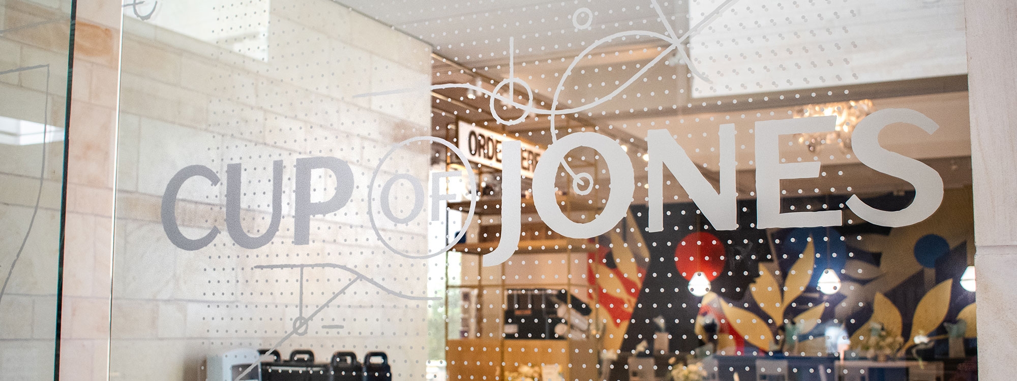 Cup of Jones logo overlaying a window.