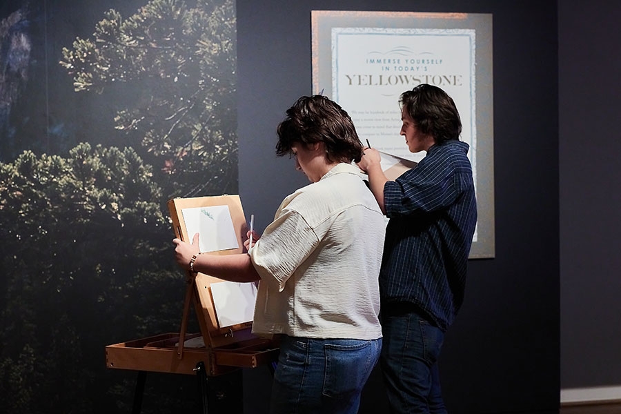 Two people viewing a piece of art from the Yellowstone Collection.