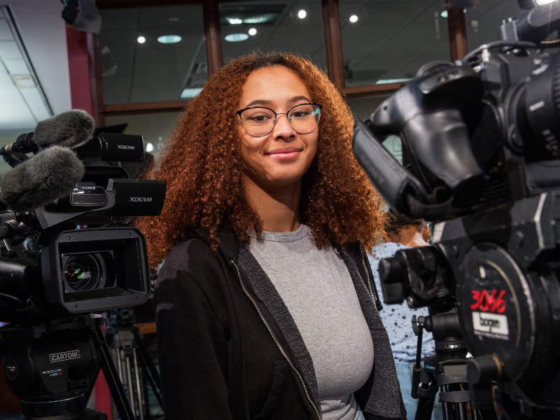 A Gaylord student surrounded by film equipment.