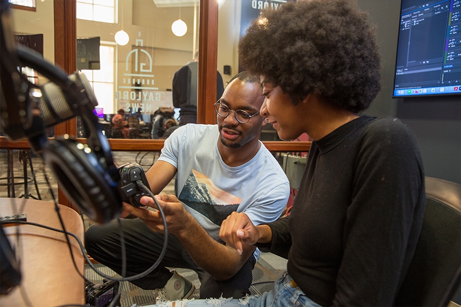 Gaylord College students working on a podcast.