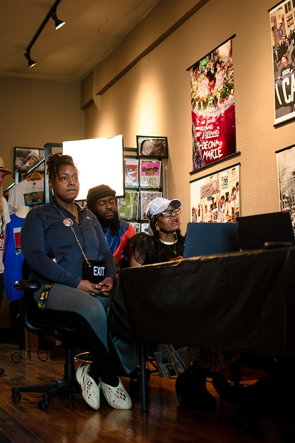 Three people sitting in a cafe.