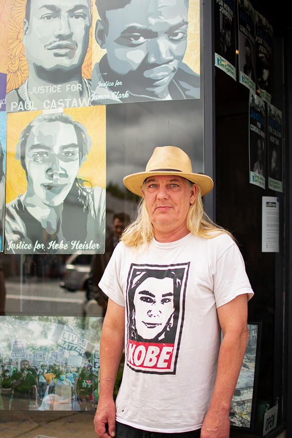 Jason Heisler, father of Kobe Dimock-Heisler, stands near a painting of his son.