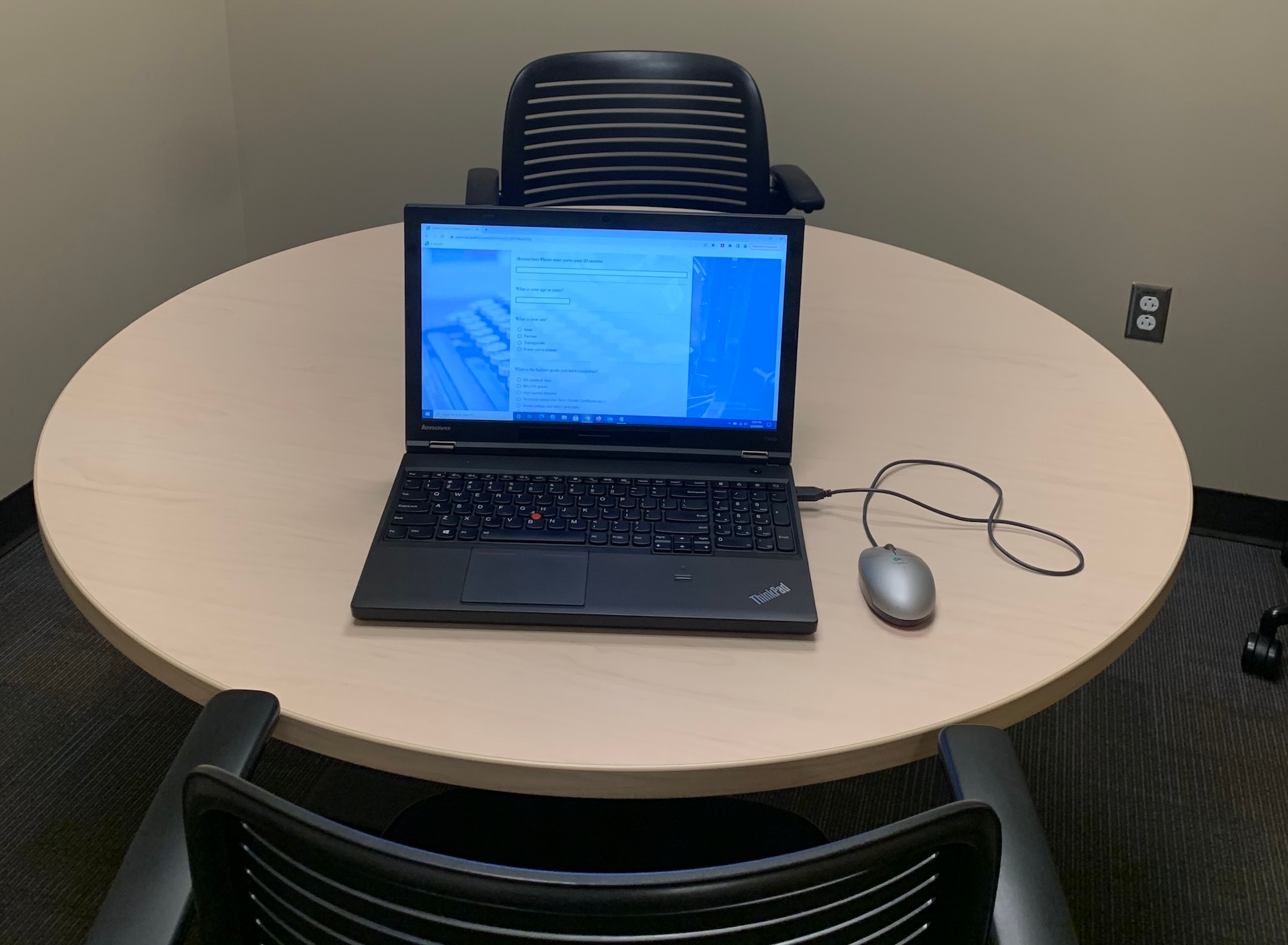 Laptop on table for pre-experiment survey in offline data collection room.