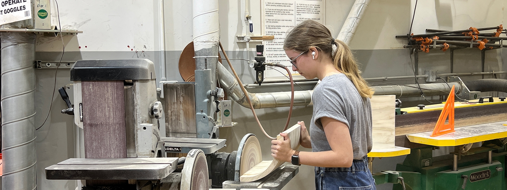 A student working with equipment in the Furniture Design Studio.