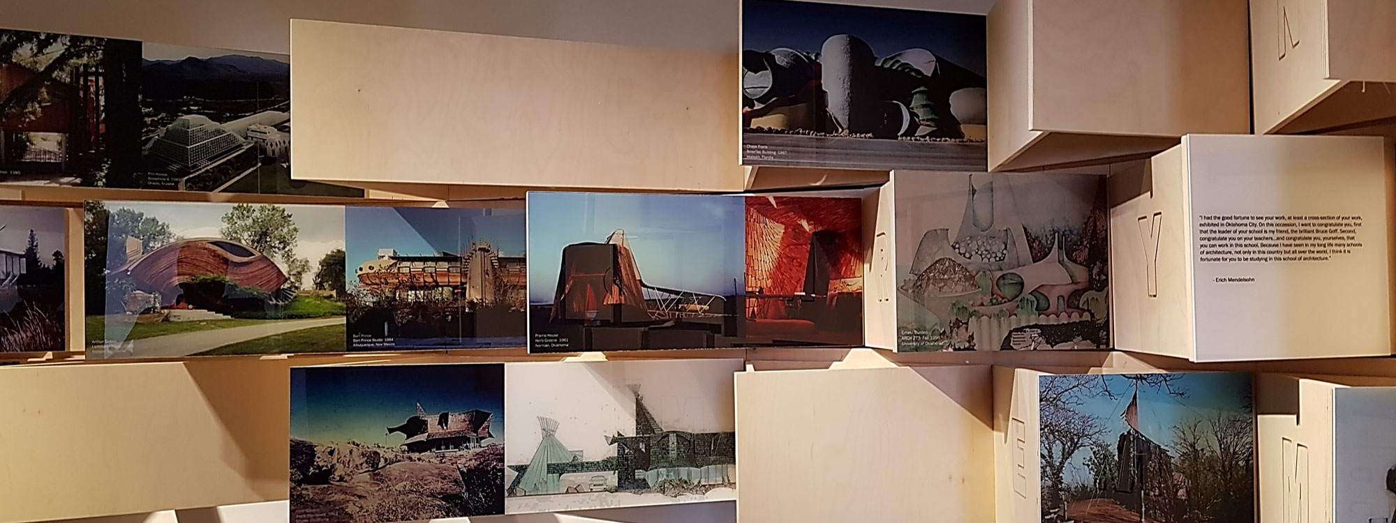 Wooden panels showing key works from the American School of Architecture.