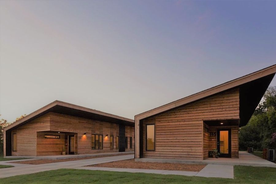 Photograph of modern wood framed house at dusk