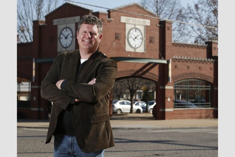 Ed Sharrer in front of a brick building.