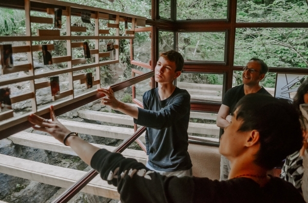 Students looking at Fallingwater interior features.