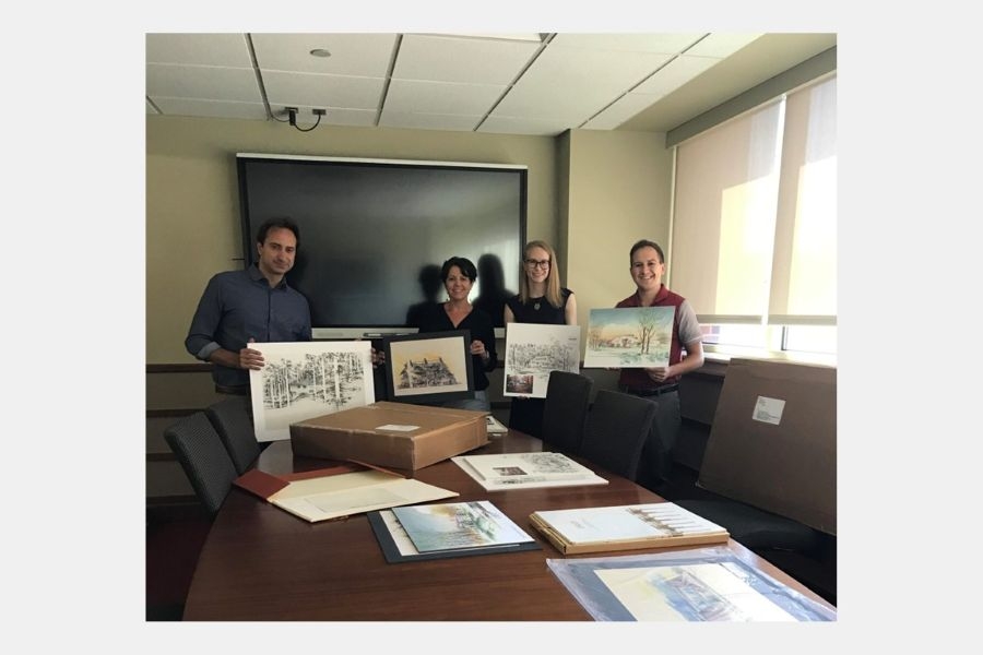 American School team members with artwork from the collection.